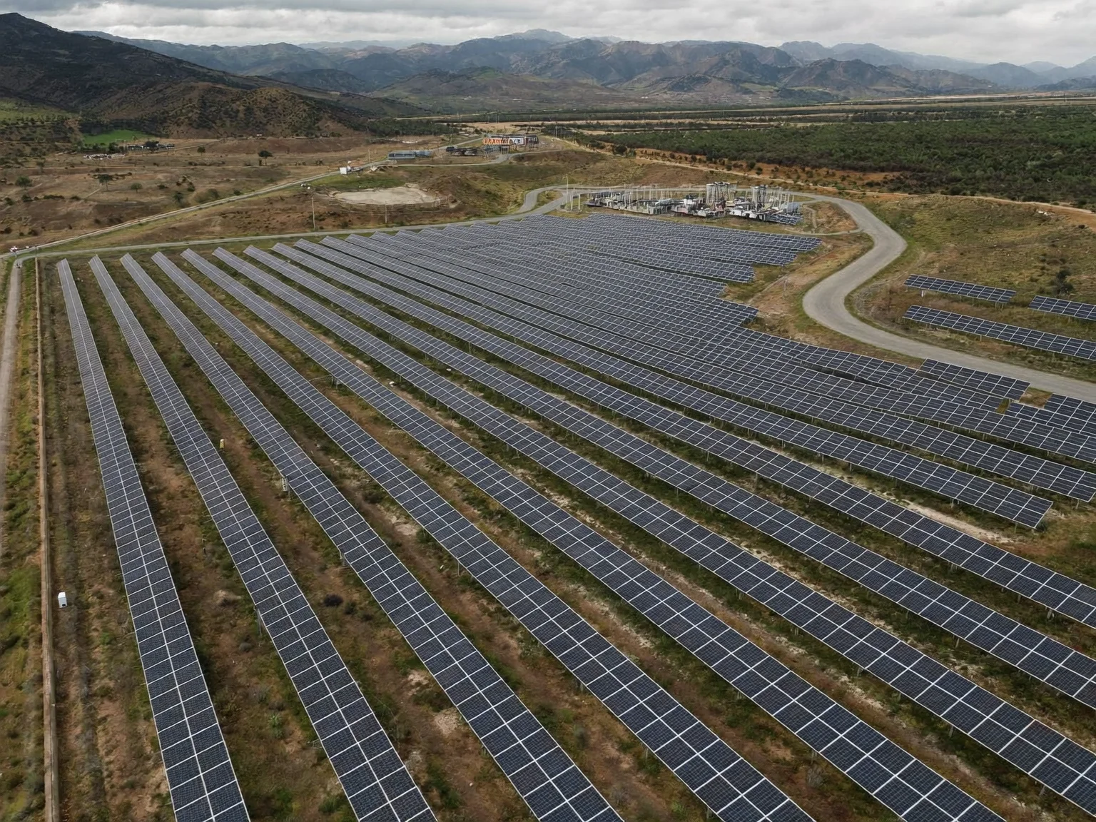 Aerial drone photo of a utility-scale solar farm (AI-generated sample image)