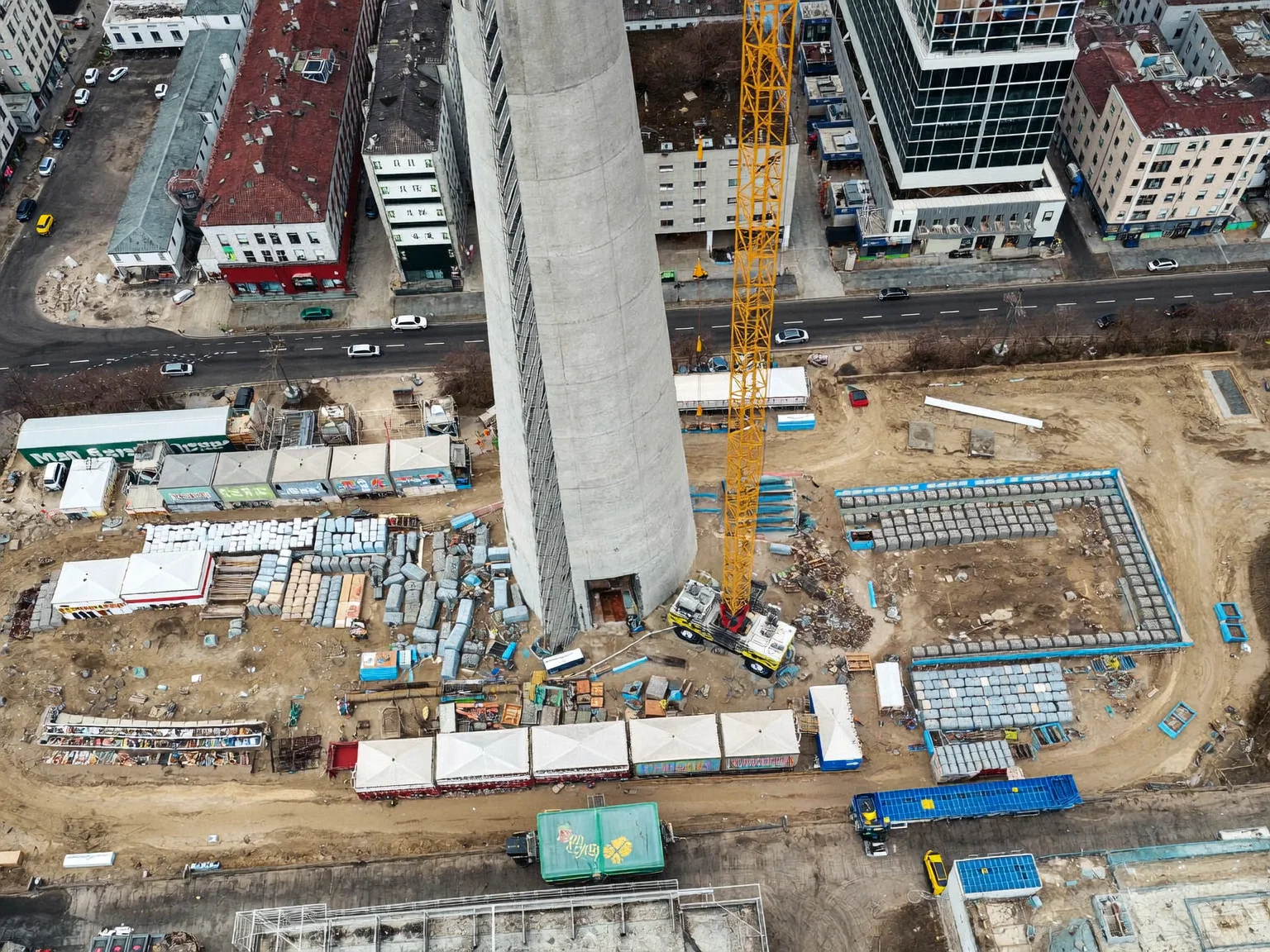 Top-down drone view of an insured urban construction site (AI-generated sample image)