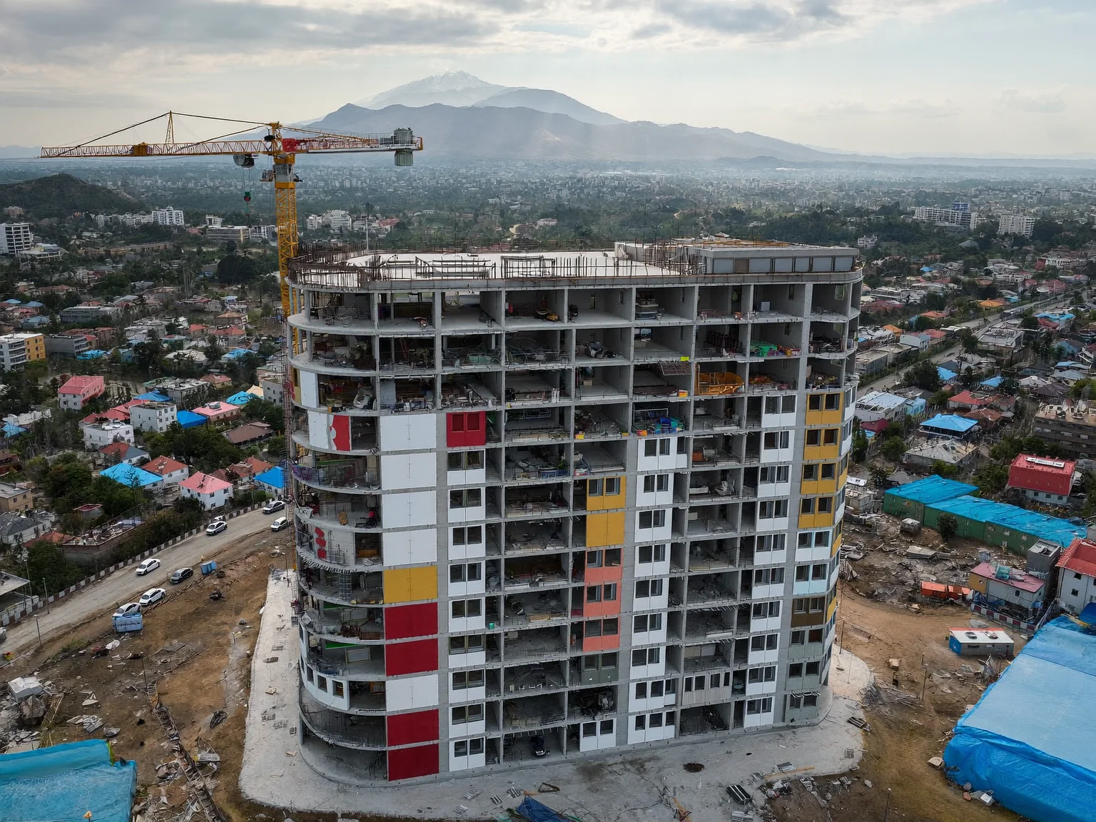 Oblique drone photo of a tower under construction used for progress monitoring (AI-generated sample image)