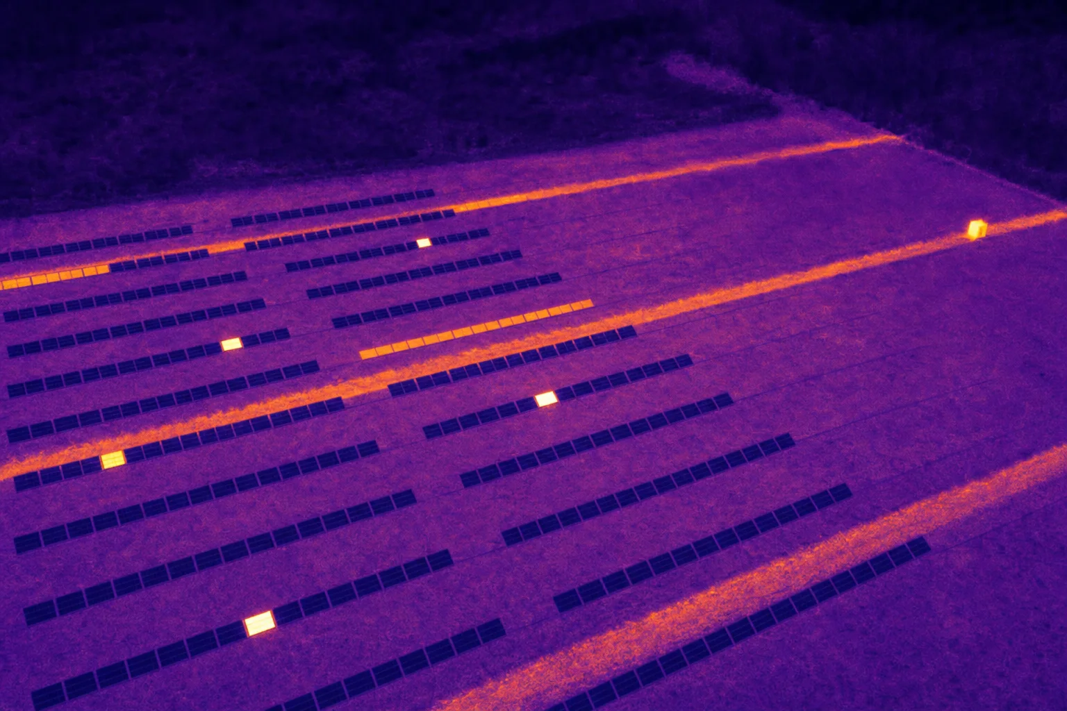Thermal drone image of a solar farm with hot cells (AI-generated sample image)